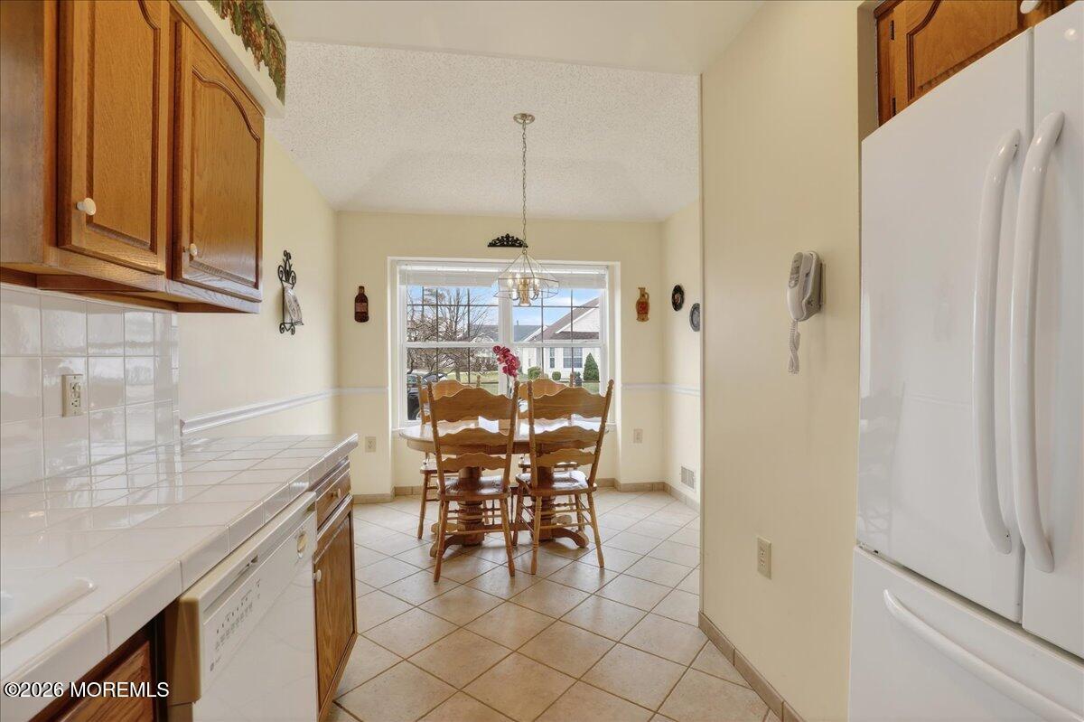 18 Angus Court Jackson, NJ 08527 - Photo 13 of 45 a dining room with furniture and a chandelier