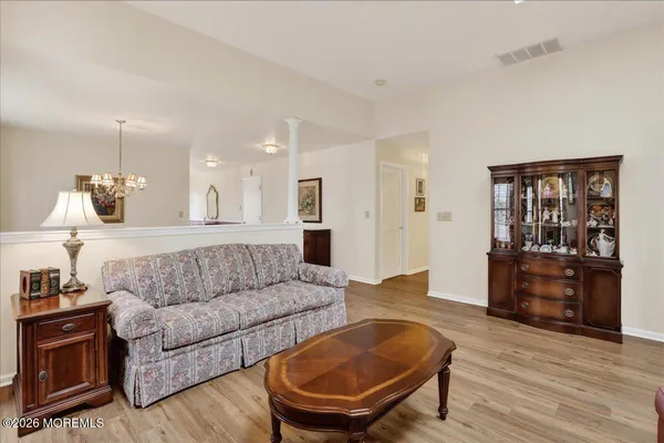 a living room with furniture and a wooden floor