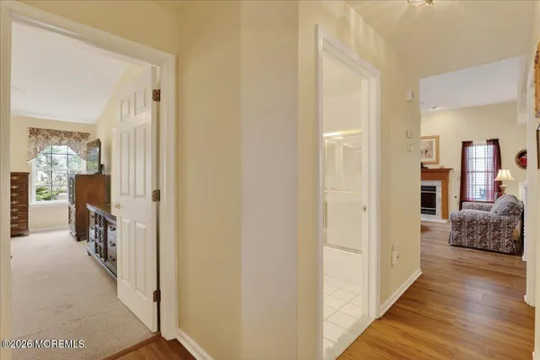 a view of a hallway with furniture and wooden floor