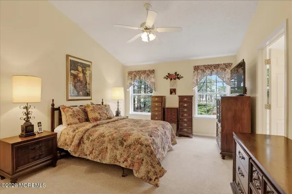 a bedroom with a large bed and a chandelier