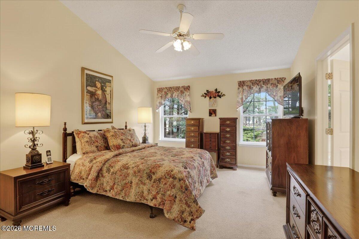 18 Angus Court Jackson, NJ 08527 - Photo 21 of 45 a bedroom with a large bed and a chandelier