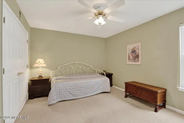 a spacious bedroom with a bed and a chandelier