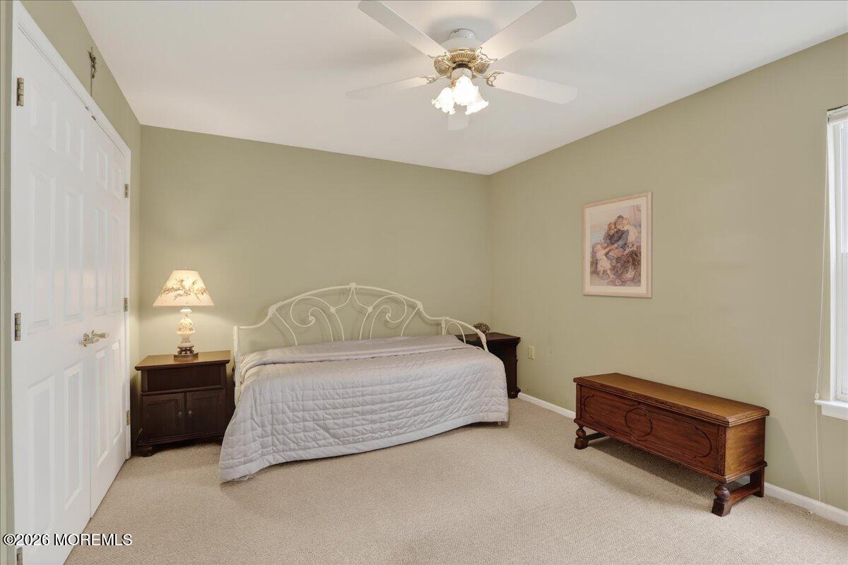 18 Angus Court Jackson, NJ 08527 - Photo 27 of 45 a spacious bedroom with a bed and a chandelier