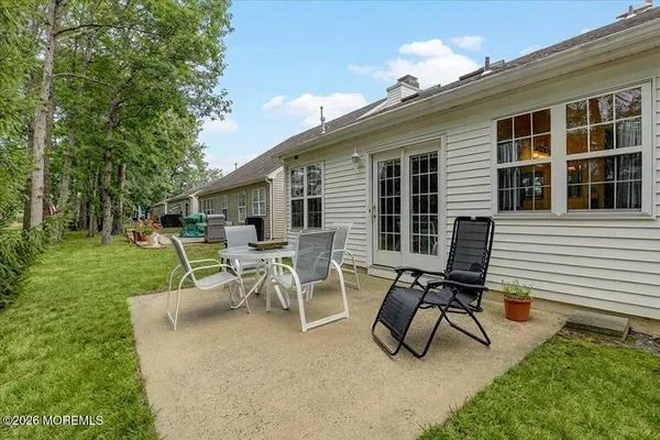 a view of a backyard with a patio and a garden