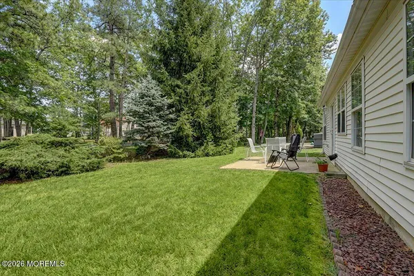 a view of a backyard with sitting area