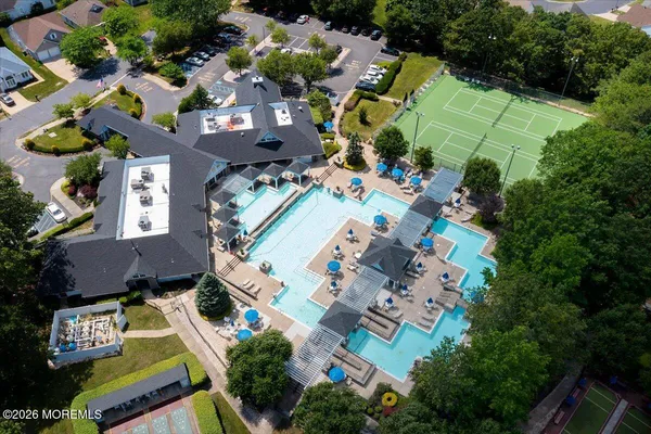 an aerial view of a house with a yard pool outdoor seating and yard