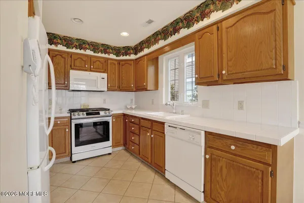 a kitchen with stainless steel appliances granite countertop a sink and cabinets