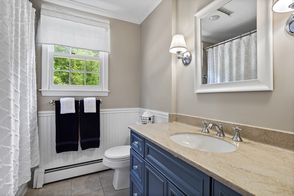 24 Devincent Drive Stow, MA 01775 - Photo 27 of 39 a bathroom with a granite countertop toilet a sink and a window
