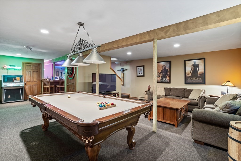 24 Devincent Drive Stow, MA 01775 - Photo 29 of 39 a living room with furniture a table and kitchen view