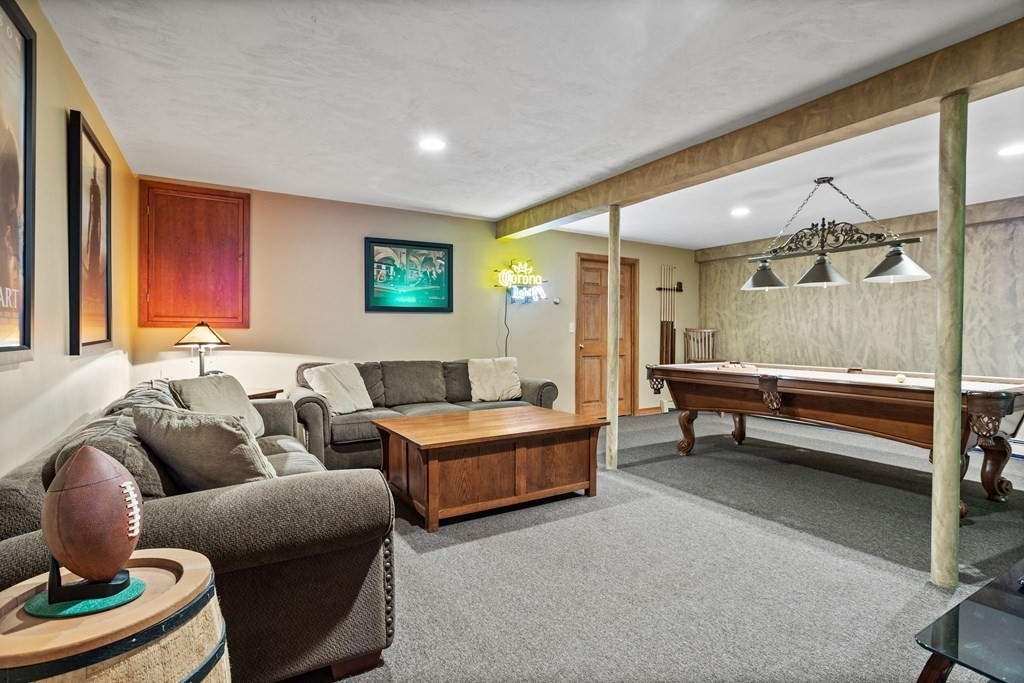 24 Devincent Drive Stow, MA 01775 - Photo 30 of 39 a living room with furniture a rug and a window