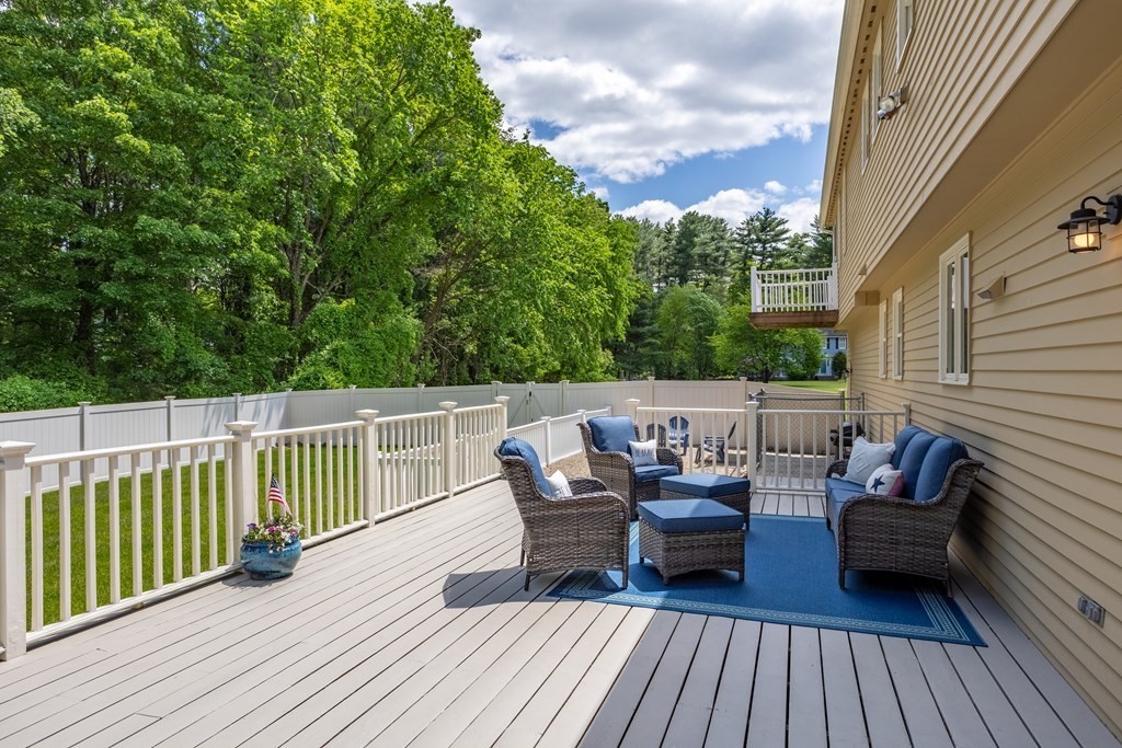 24 Devincent Drive Stow, MA 01775 - Photo 34 of 39 a balcony with wooden floor table and chairs