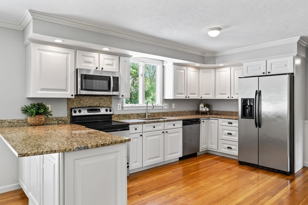 24 Devincent Drive Stow, MA 01775 - Photo 4 of 39 a kitchen with stainless steel appliances granite countertop a stove a sink and a refrigerator