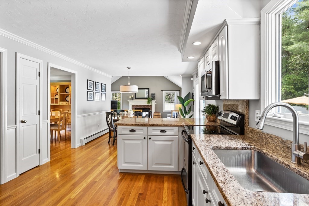 24 Devincent Drive Stow, MA 01775 - Photo 5 of 39 a kitchen with stainless steel appliances granite countertop a sink stove and refrigerator