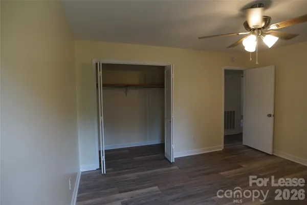 a view of a room with wooden floor