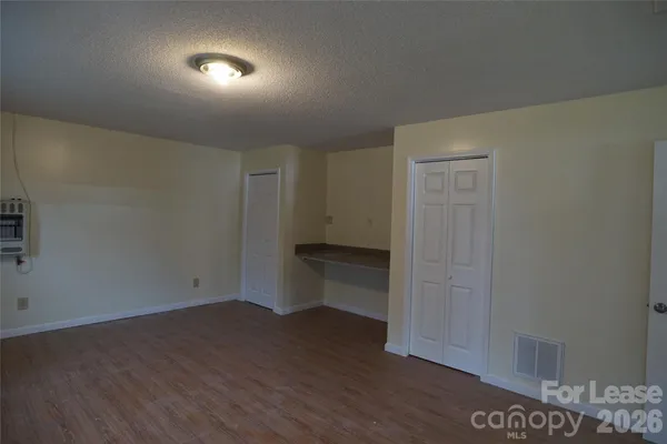 a view of an empty room and wooden floor