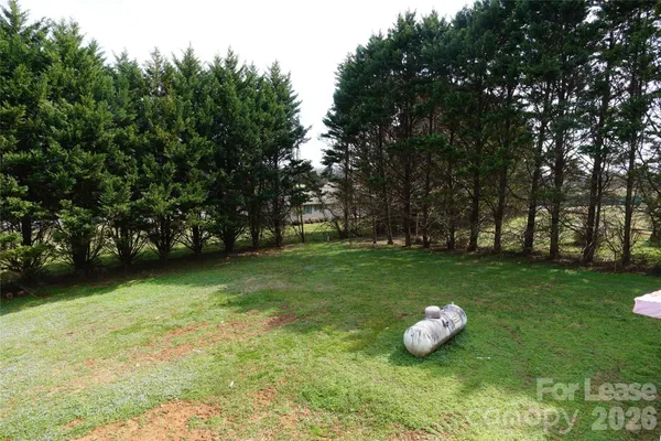 a white house with a trees in the background