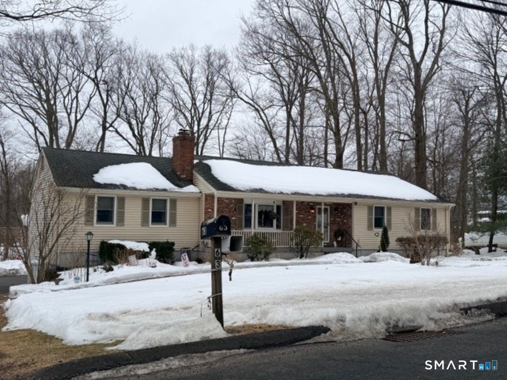 a front view of a house with garden and patio