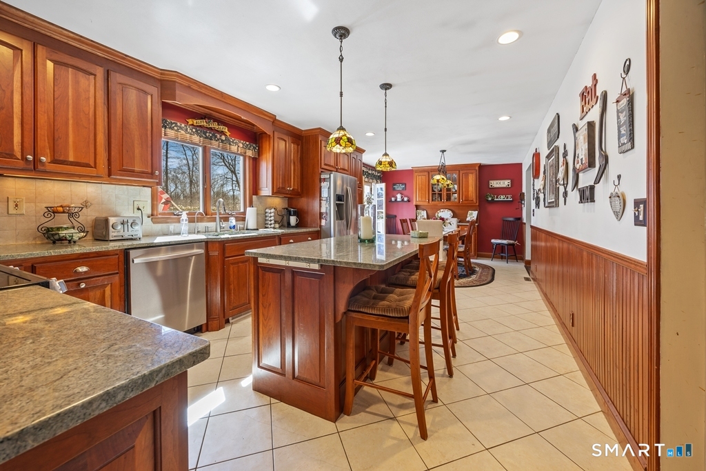 63 Lyman Road Wolcott, CT 06716 - Photo 17 of 70 a kitchen with stainless steel appliances granite countertop a sink a stove and a wooden floors