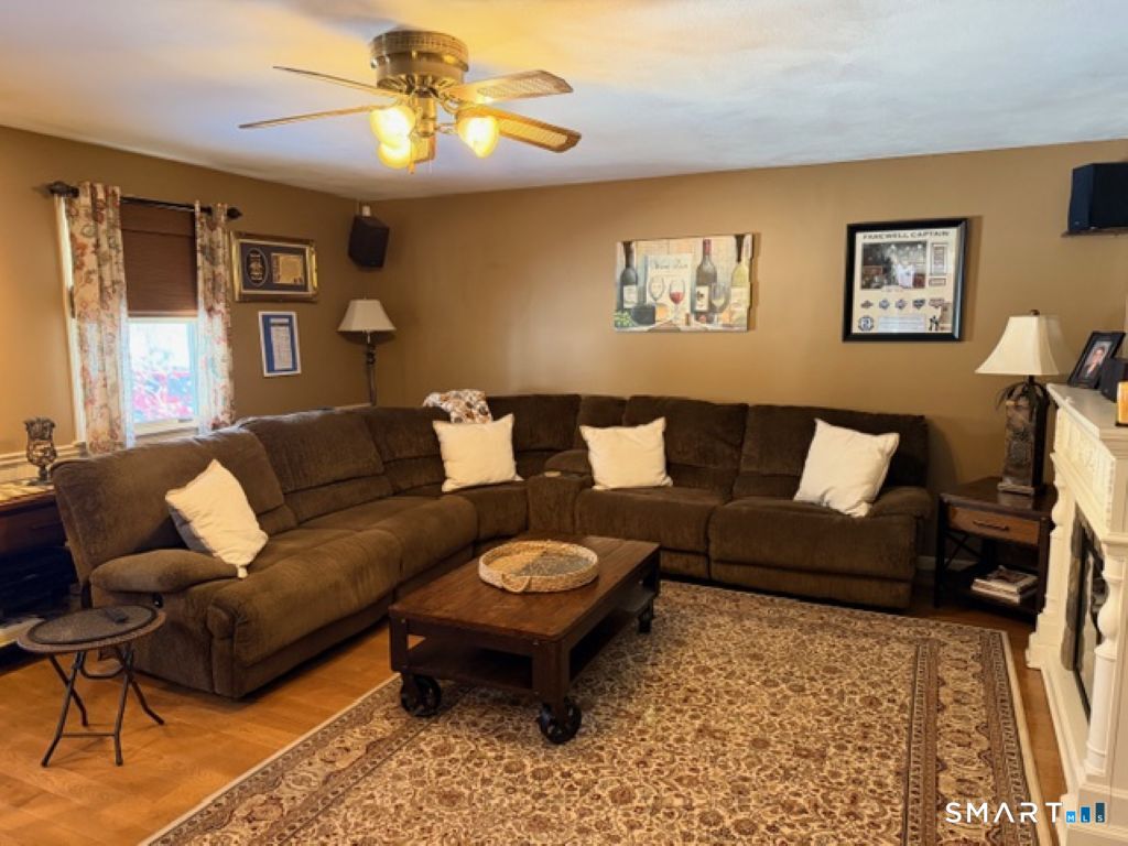 63 Lyman Road Wolcott, CT 06716 - Photo 23 of 70 a living room with furniture a rug and a chandelier