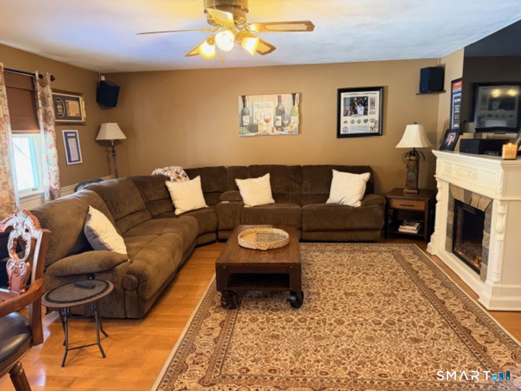 63 Lyman Road Wolcott, CT 06716 - Photo 25 of 70 a living room with furniture and a fireplace