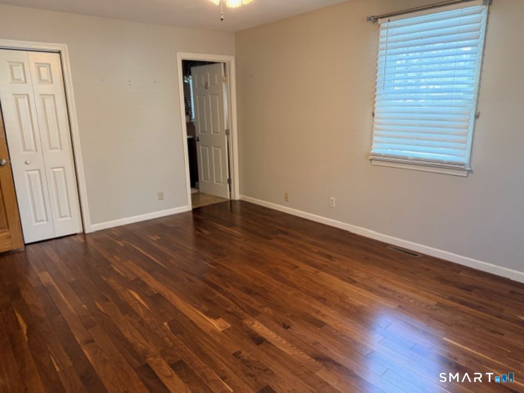 63 Lyman Road Wolcott, CT 06716 - Photo 28 of 70 a view of an empty room with wooden floor and a window