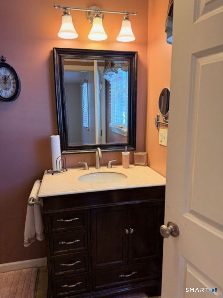 63 Lyman Road Wolcott, CT 06716 - Photo 30 of 70 a bathroom with a sink vanity and a mirror