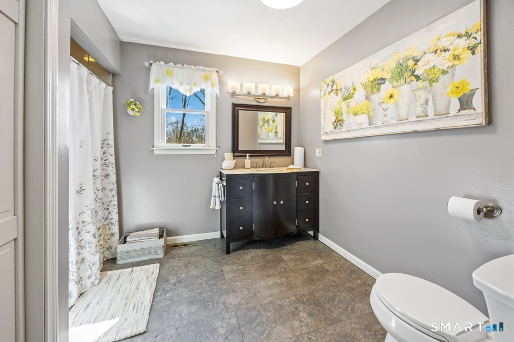 63 Lyman Road Wolcott, CT 06716 - Photo 31 of 70 a bathroom with a granite countertop sink mirror vanity and toilet