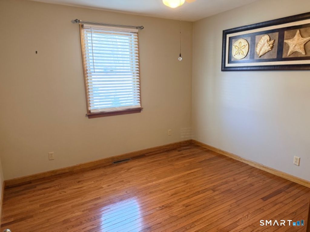 63 Lyman Road Wolcott, CT 06716 - Photo 36 of 70 a view of empty room with wooden floor and fan