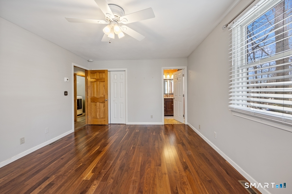 63 Lyman Road Wolcott, CT 06716 - Photo 39 of 70 a view of an empty room with window and wooden floor