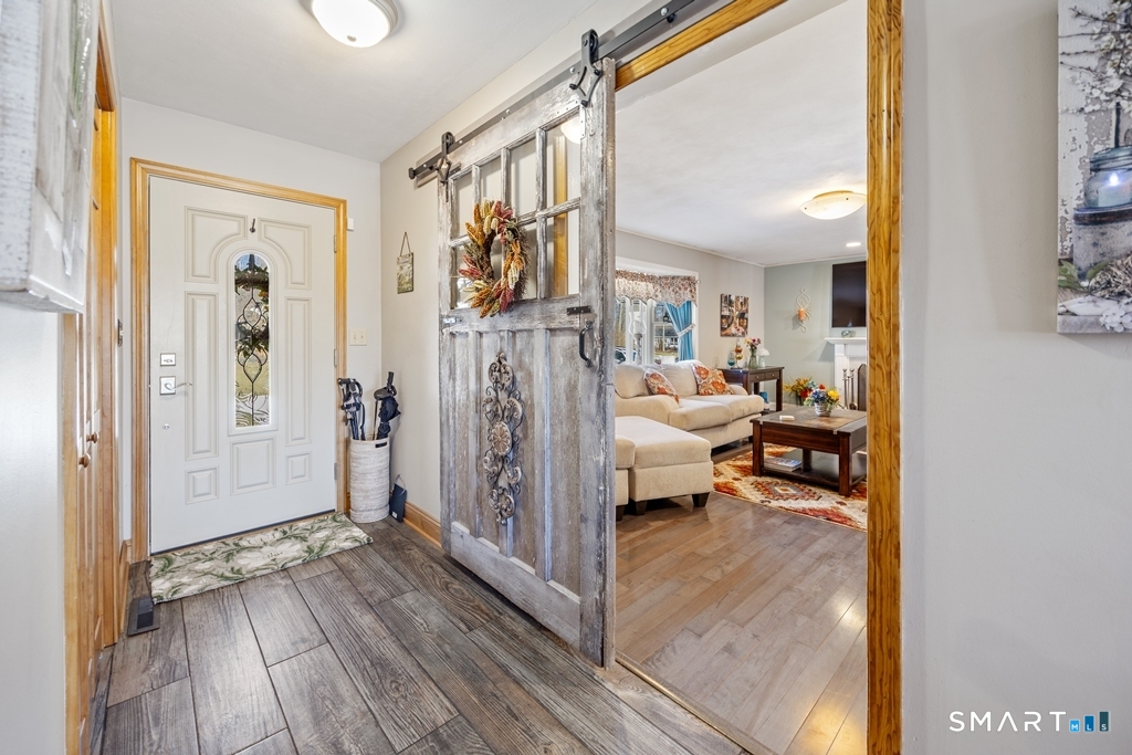63 Lyman Road Wolcott, CT 06716 - Photo 4 of 70 a view of a livingroom with furniture and hardwood floor
