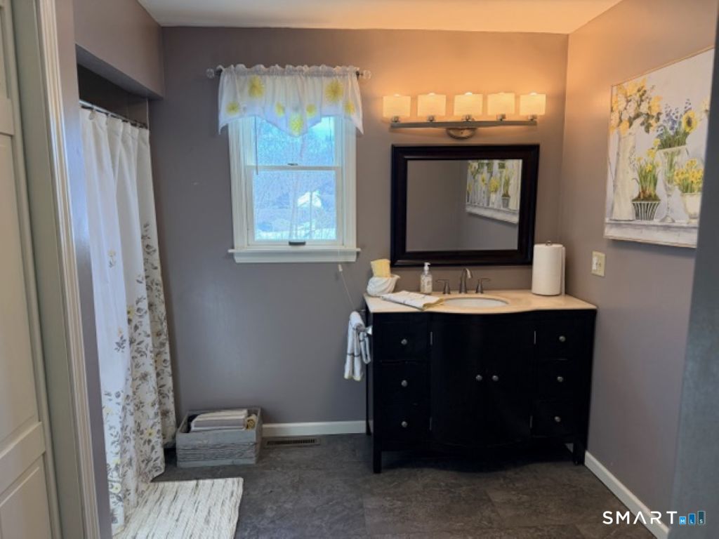 63 Lyman Road Wolcott, CT 06716 - Photo 44 of 70 a bathroom with a sink and a mirror