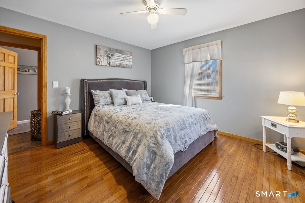 63 Lyman Road Wolcott, CT 06716 - Photo 45 of 70 a bedroom with a bed and a chandelier