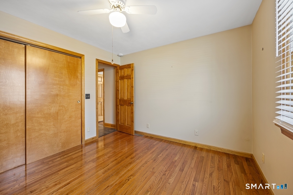63 Lyman Road Wolcott, CT 06716 - Photo 47 of 70 a view of an empty room with wooden floor and a window