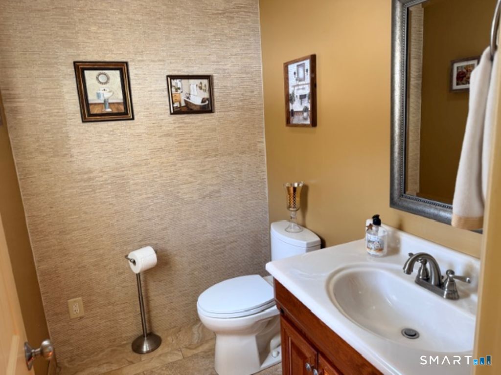 63 Lyman Road Wolcott, CT 06716 - Photo 48 of 70 a bathroom with a sink and mirror with toilet