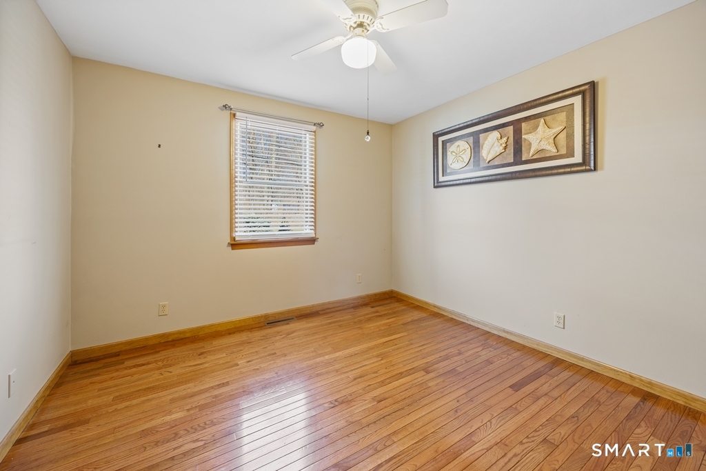 63 Lyman Road Wolcott, CT 06716 - Photo 49 of 70 a view of an empty room with wooden floor and a window
