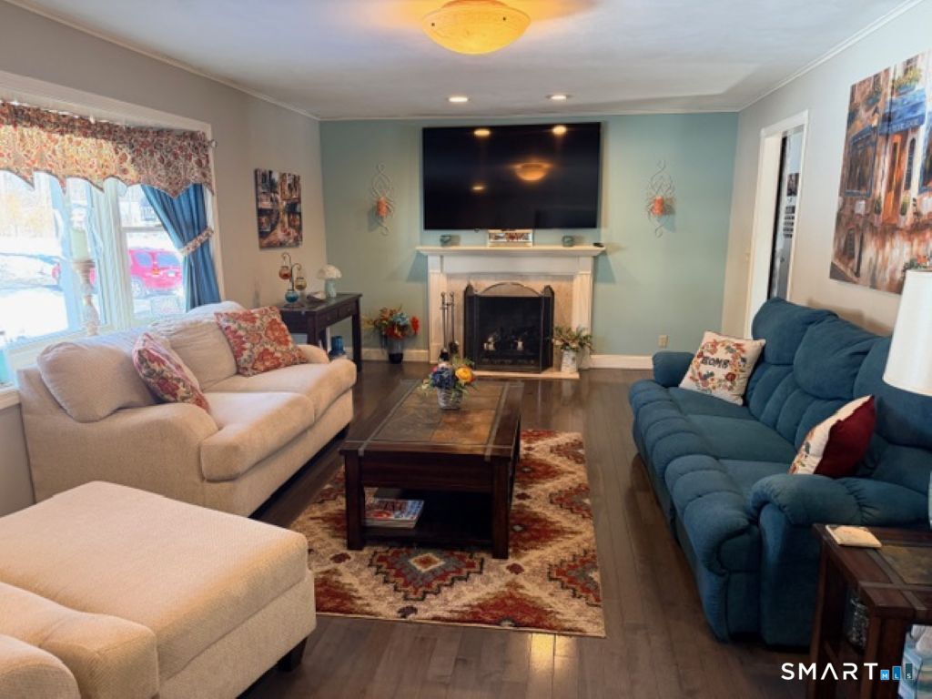 63 Lyman Road Wolcott, CT 06716 - Photo 5 of 70 a living room with furniture a flat screen tv and a fireplace