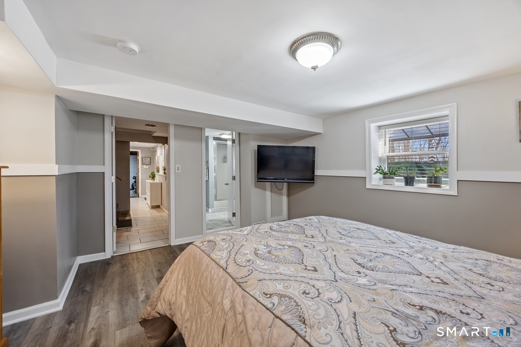 63 Lyman Road Wolcott, CT 06716 - Photo 53 of 70 a bedroom with a bed and a flat screen tv