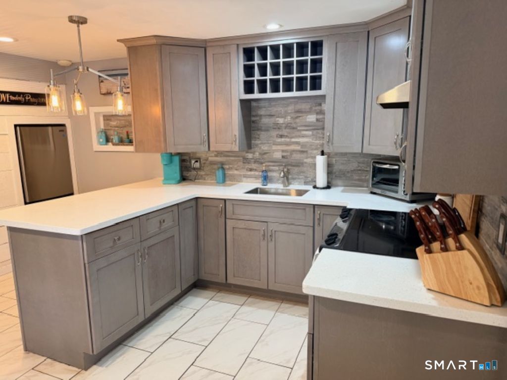 63 Lyman Road Wolcott, CT 06716 - Photo 54 of 70 a kitchen with a sink a stove and cabinets
