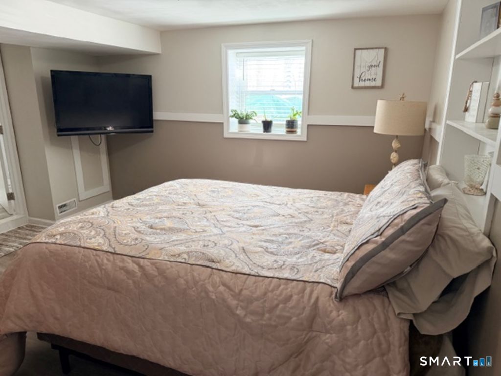 63 Lyman Road Wolcott, CT 06716 - Photo 62 of 70 a bedroom with a bed and a flat screen tv