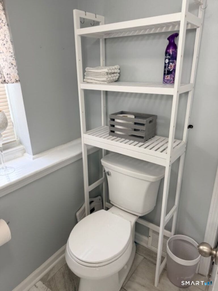 63 Lyman Road Wolcott, CT 06716 - Photo 66 of 70 a bathroom with a toilet a sink and a window