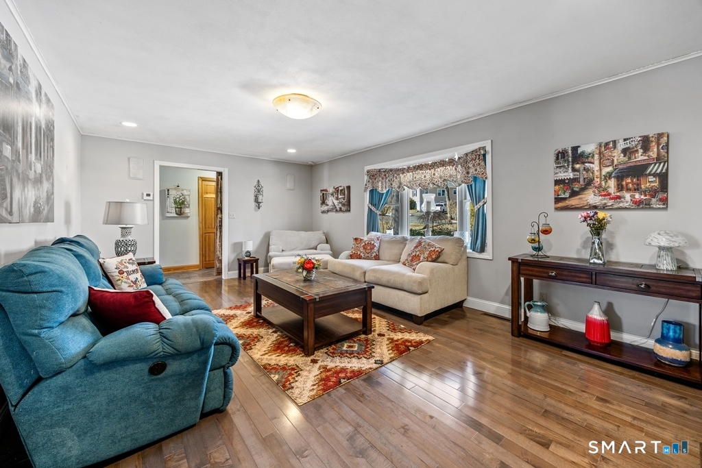 63 Lyman Road Wolcott, CT 06716 - Photo 9 of 70 a living room with furniture and a wooden floor