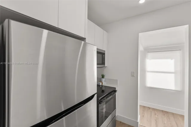 a view of room with window and wooden floor