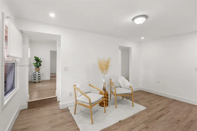 a living room with furniture and a dining area