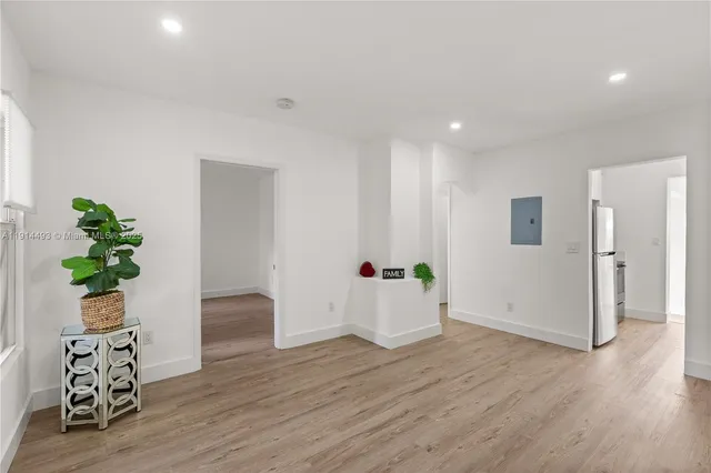 a view of an empty room and wooden floor