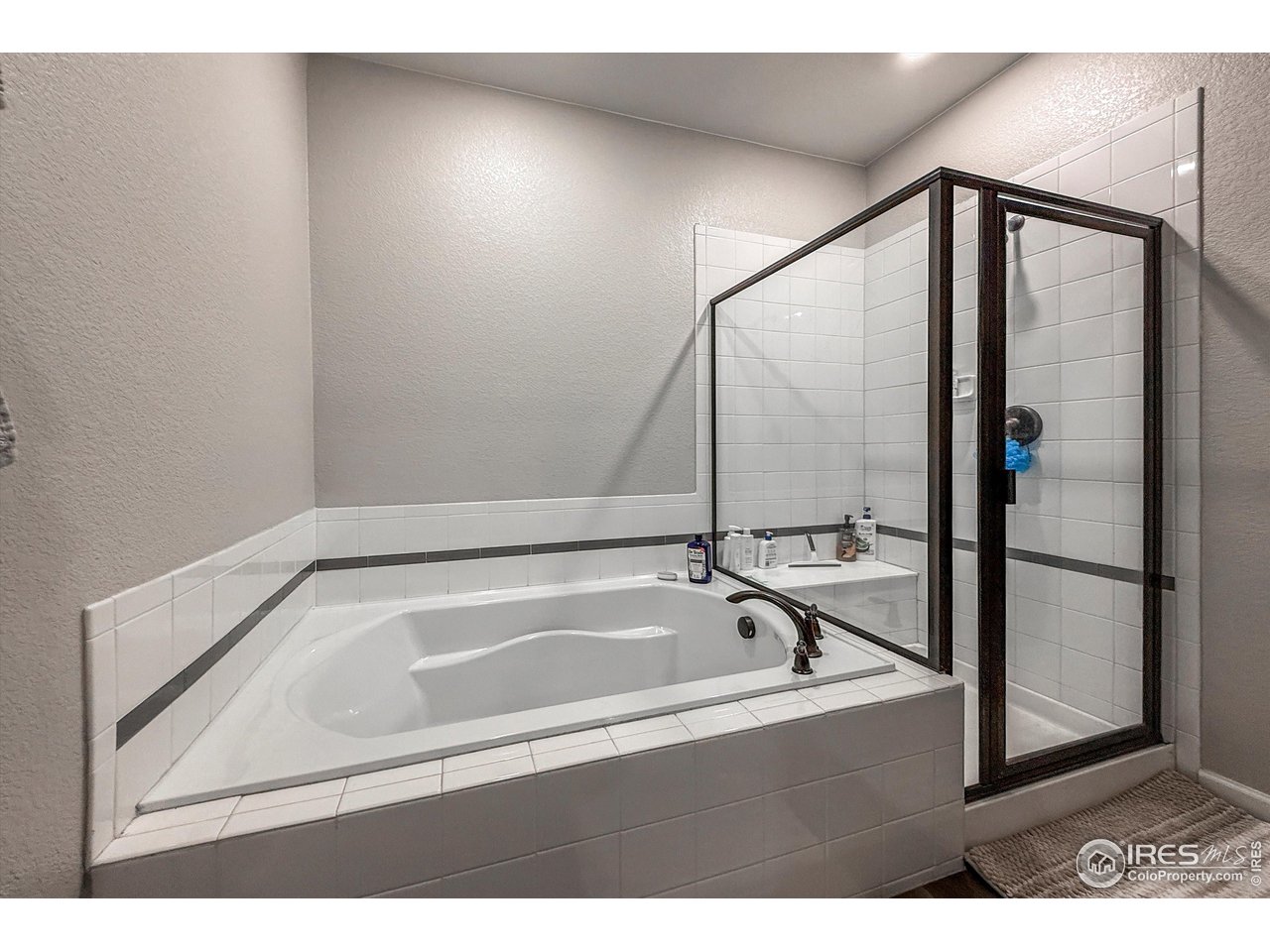2287 Murray Street Mead, CO 80542 - Photo 19 of 38 a bathroom with a bathtub and a shower