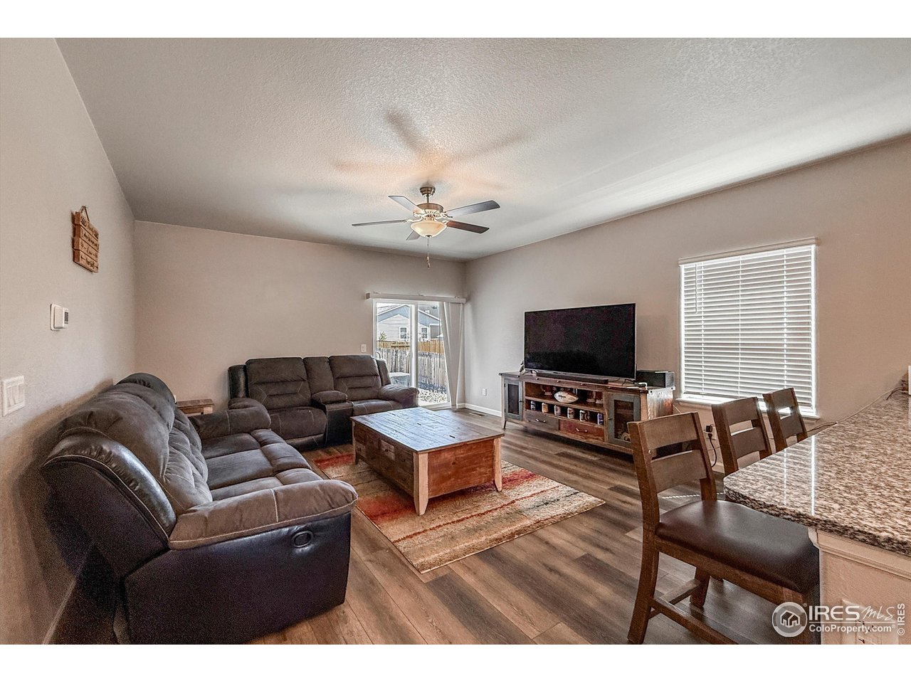 2287 Murray Street Mead, CO 80542 - Photo 7 of 38 a living room with furniture and a flat screen tv