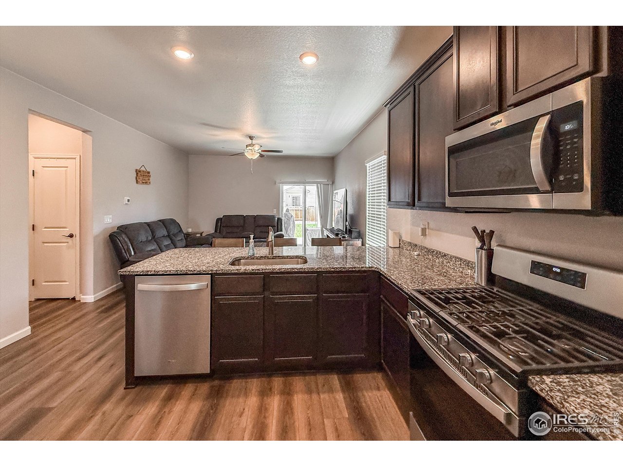 2287 Murray Street Mead, CO 80542 - Photo 10 of 38 a kitchen with a sink stove and microwave