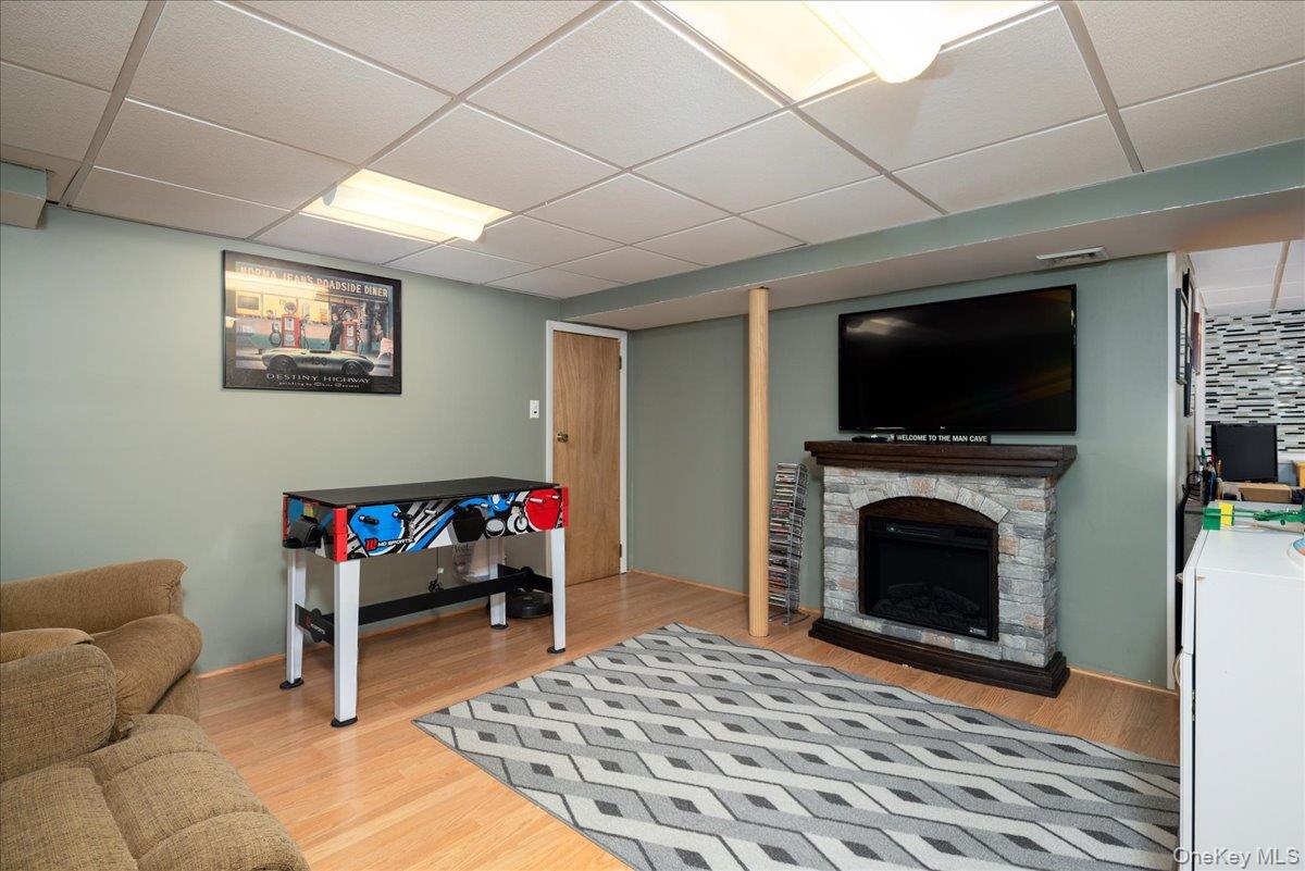 11 Adelphi Road Hicksville, NY 11801 - Photo 16 of 26 a living room with furniture and a fireplace