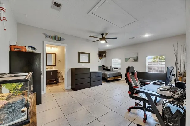 a view of a patio with table and chairs under an umbrella with a barbeque