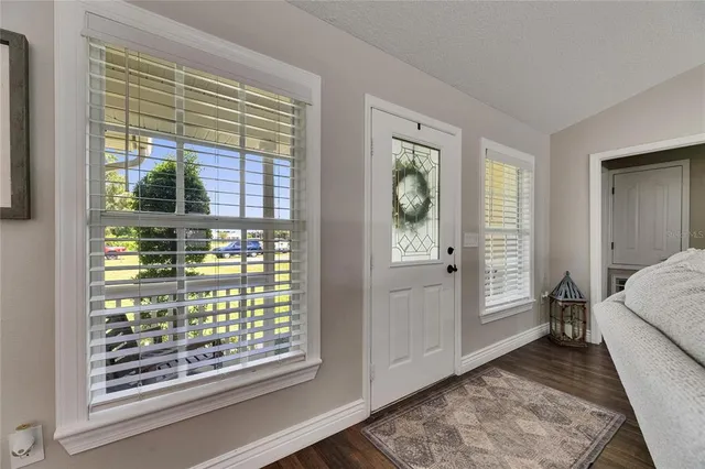 a living room with furniture piano and a window